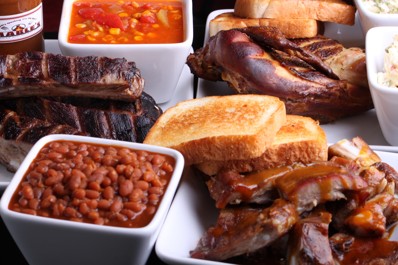 A spread of Mable's smoked meats with toast and sides